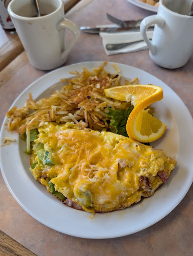 Cheese omelette with hash browns and an orange slice at Sugar Shack Cafe